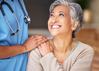 A woman smiling up at her ImpactMD Accident Care doctor.