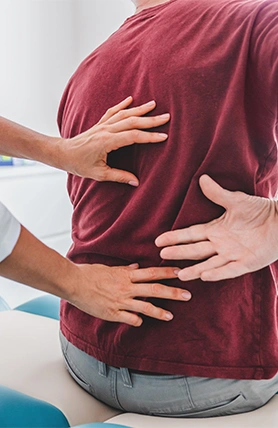 An accident care doctor in Oklahoma treating a patient's back.