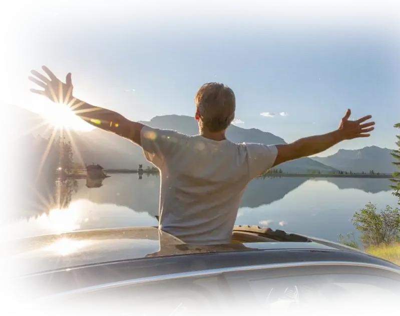 A man opening his arms in happiness after accident care provided him pain relief.