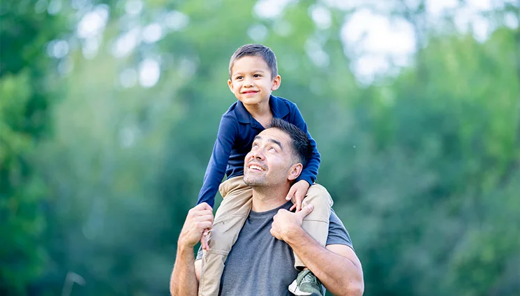 A father with his son after receiving back pain treatment.