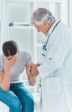 An Oklahoma doctor comforting a patient in pain.
