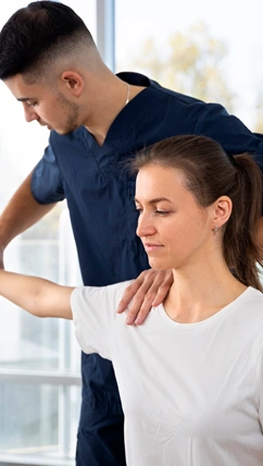 A physical therapist treating a patient with an injury.