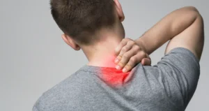 A man holding his neck that is in pain.