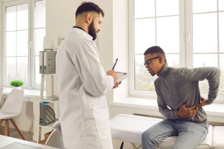 A back pain doctor talking to a patient.