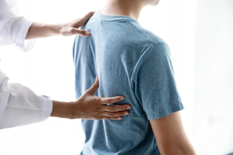 A back pain doctor evaluating a patient.