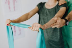 woman working with physical therapist
