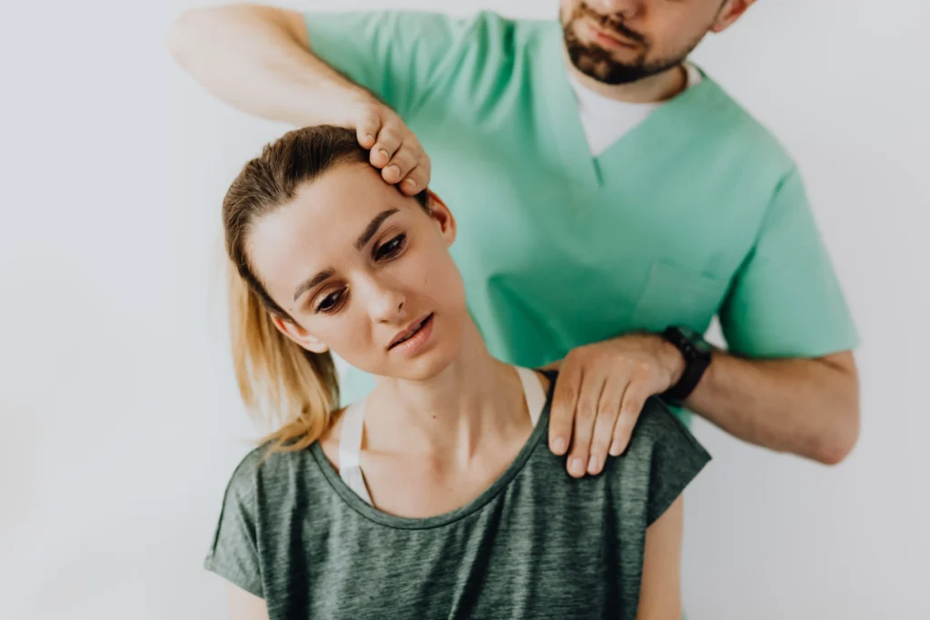 A woman receives neck treatment from a healthcare professional, symbolizing recovery after a car accident-related neck injury.
