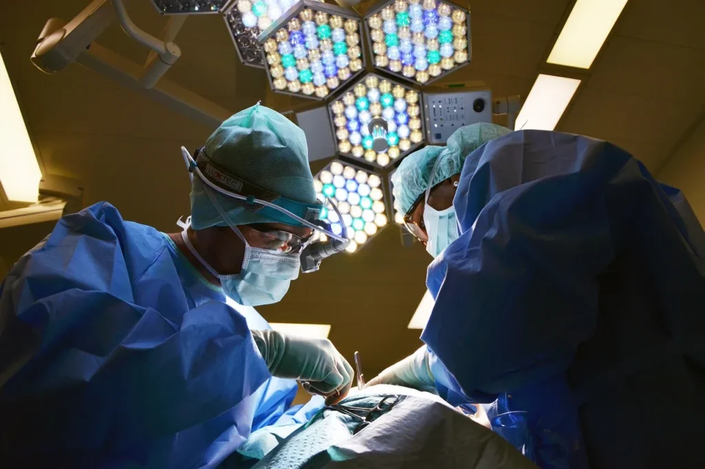 Surgeons performing a medical procedure under bright operating room lights, representing treatments such as radiofrequency ablation.